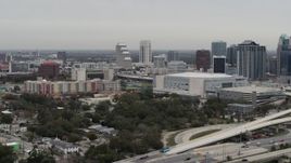 5.7K aerial stock footage flying by apartment complex, Amway Center and city skyline, Downtown Orlando, Florida Aerial Stock Footage | DX0003_234_024