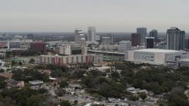 5.7K aerial stock footage passing by apartment complex near Amway Center and city skyline, Downtown Orlando, Florida Aerial Stock Footage | DX0003_234_025