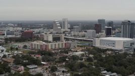 5.7K aerial stock footage flying past apartment complex near Amway Center and city skyline, Downtown Orlando, Florida Aerial Stock Footage | DX0003_234_026