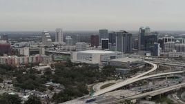5.7K aerial stock footage stationary and slowly flying by Amway Center and city skyline, Downtown Orlando, Florida Aerial Stock Footage | DX0003_234_028