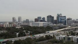 5.7K aerial stock footage fly away from Amway Center arena and city skyline, Downtown Orlando, Florida Aerial Stock Footage | DX0003_234_031