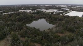 5.7K aerial stock footage approach small lake and forest trees, Orlando, Florida Aerial Stock Footage | DX0003_234_055