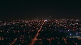 HD stock footage aerial video fly over West Side suburbs to approach Downtown Chicago, Illinois skyline at night Aerial Stock Footage | ED0001_000003