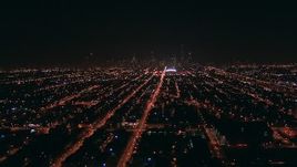 HD stock footage aerial video fly over the West Side to approach Downtown Chicago, Illinois skyline at night Aerial Stock Footage | ED0001_000004