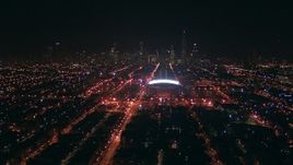 HD stock footage aerial video approach United Center arena and the Downtown Chicago, Illinois skyline at night from the West Side Aerial Stock Footage | ED0001_000006