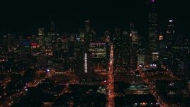 HD stock footage aerial video follow Monroe Street at night toward skyscrapers in Downtown Chicago, Illinois Aerial Stock Footage | ED0001_000009
