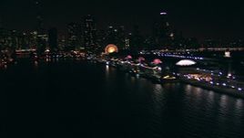 HD stock footage aerial video pan across historic Navy Pier and the skyscrapers of Downtown Chicago's skyline at night, Illinois Aerial Stock Footage | ED0001_000029