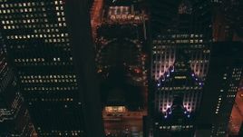 HD stock footage aerial video fly between skyscrapers, approach Jay Pritzker Pavilion and AT&T Park at night, Downtown Chicago, Illinois Aerial Stock Footage | ED0001_000045