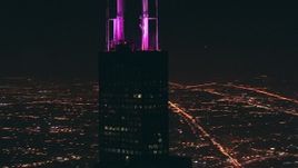 HD stock footage aerial video orbit Willis Tower skyscraper and zoom to wider view at night, Downtown Chicago, Illinois Aerial Stock Footage | ED01_094