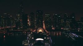 HD stock footage aerial video of Downtown Chicago skyscrapers, tilt to Navy Pier at night, Illinois Aerial Stock Footage | ED01_105