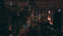 HD stock footage aerial video follow the Chicago River toward Trump Tower skyscraper at night, Downtown Chicago, Illinois Aerial Stock Footage | ED01_109