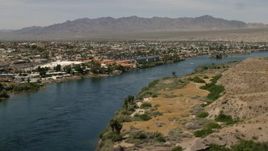 4K aerial stock footage pan across riverfront homes and apartments on the Colorado River in Bullhead City, Arizona Aerial Stock Footage | FG0001_000011