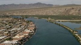 4K aerial stock footage of a bend in the Colorado River and waterfront houses with docks in Bullhead City, Arizona Aerial Stock Footage | FG0001_000017