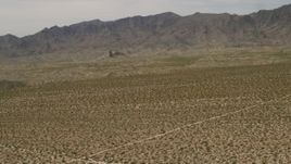 4K aerial stock footage of Dead Mountains Wilderness Area seen from flat Mojave Desert plain in Laughlin, Nevada Aerial Stock Footage | FG0001_000024