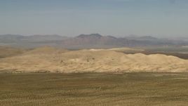 4K aerial stock footage of Mojave Desert hills and mountains in the background in San Bernardino County, California Aerial Stock Footage | FG0001_000051
