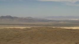 4K aerial stock footage of Mojave Desert mountains seen from hills in San Bernardino County, California Aerial Stock Footage | FG0001_000052