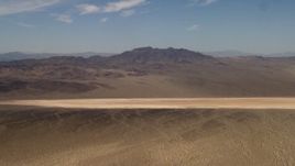 4K aerial stock footage of a dry lake near Mojave Desert mountains in San Bernardino County, California Aerial Stock Footage | FG0001_000059