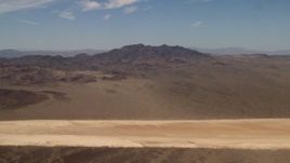 4K aerial stock footage of a dry lake and Mojave Desert mountains in San Bernardino County, California Aerial Stock Footage | FG0001_000062