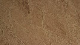 4K aerial stock footage of looking down at a barren Mojave Desert plain in San Bernardino County, California Aerial Stock Footage | FG0001_000072