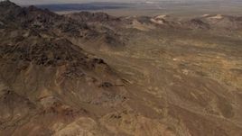4K aerial stock footage tilt from Mojave Desert mountains to reveal Pisgah Crater in San Bernardino County, California Aerial Stock Footage | FG0001_000078