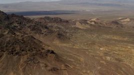 4K aerial stock footage of the Pisgah Crater behind rugged Mojave Desert mountains in San Bernardino County, California Aerial Stock Footage | FG0001_000079
