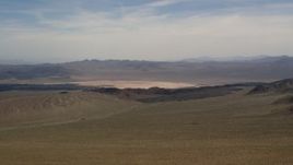 4K aerial stock footage of a dry lake and distant mountains in the Mojave Desert, San Bernardino County, California Aerial Stock Footage | FG0001_000095