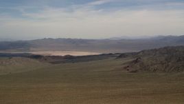 4K aerial stock footage of a dry lake and mountains in the Mojave Desert, San Bernardino County, California Aerial Stock Footage | FG0001_000097