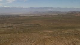 4K aerial stock footage pan across desert plain and road to reveal Iron Ridge in the Mojave Desert, San Bernardino County, California Aerial Stock Footage | FG0001_000104