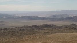 4K aerial stock footage of passing Iron Ridge mountains and small ranges in the Mojave Desert, San Bernardino County, California Aerial Stock Footage | FG0001_000109