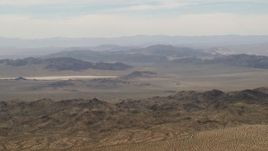 4K aerial stock footage of Iron Ridge mountains and small ridges in the background in the Mojave Desert, San Bernardino County, California Aerial Stock Footage | FG0001_000110