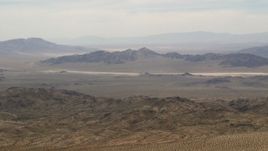 4K aerial stock footage wide view of Iron Ridge mountains and distant desert ridges in the Mojave Desert, San Bernardino County, California Aerial Stock Footage | FG0001_000112