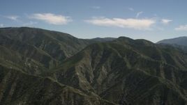 4K aerial stock footage pan back and forth across green mountains in the San Gabriel Mountains, California Aerial Stock Footage | FG0001_000160