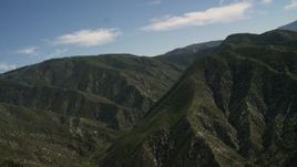4K aerial stock footage pan across and approach green mountains in the San Gabriel Mountains, California Aerial Stock Footage | FG0001_000161