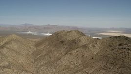 4K aerial stock footage of desert mountains and the Ivanpah Solar Electric Generating System in California Aerial Stock Footage | FG0001_000169