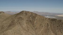 4K aerial stock footage approach desert mountain near the Ivanpah Solar Electric Generating System in California Aerial Stock Footage | FG0001_000170