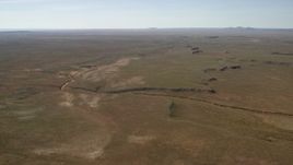 4K aerial stock footage of a dry riverbed and a desert plain in the Arizona Desert Aerial Stock Footage | FG0001_000230