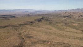 4K aerial stock footage of canyons cutting through the desert plain in the Arizona Desert Aerial Stock Footage | FG0001_000247