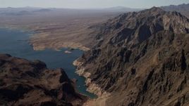 4K aerial stock footage of flying by barren mountains beside the shore of Lake Mead, Nevada Aerial Stock Footage | FG0001_000289