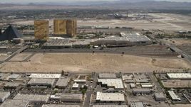 4K aerial stock footage tilt from an open dirt lot beside I-15 with light traffic in Las Vegas, Nevada to casino resorts on the Strip Aerial Stock Footage | FG0001_000351