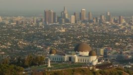 HD stock footage aerial video orbit the Griffith Observatory at sunset, and reveal the Downtown Los Angeles skyline, California Aerial Stock Footage | HDA06_09