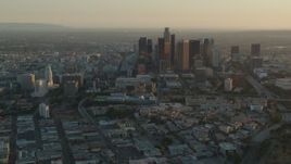 HD stock footage aerial video Los Angeles City Hall and skyscrapers at sunset in Downtown Los Angeles, California Aerial Stock Footage | HDA06_20