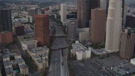 HD stock footage aerial video tilt from a bird's eye view of the 110 freeway to reveal skyscrapers in Downtown Los Angeles, California, twilight Aerial Stock Footage | HDA06_67