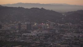 HD stock footage aerial video approach office buildings and Capitol Records at twilight in Hollywood, California Aerial Stock Footage | HDA06_80