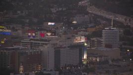HD stock footage aerial video approach Capitol Records, hotels, and office buildings at twilight, Hollywood, California Aerial Stock Footage | HDA06_81