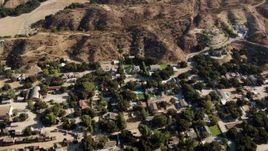 HD stock footage aerial video fly over homes and brown hills in Newhall, California Aerial Stock Footage | HDA07_17