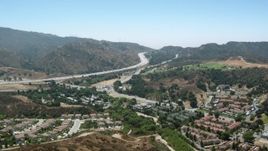HD stock footage aerial video of fly over homes toward 14 freeway in Newhall, California Aerial Stock Footage | HDA07_26