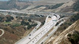 HD stock footage aerial video follow the 14 freeway to reveal the interchange at Newhall Pass, Santa Clarita, California Aerial Stock Footage | HDA07_29