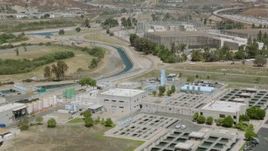 HD stock footage aerial video fly over water treatment plant to electrical substation in Granada Hills, California Aerial Stock Footage | HDA07_37