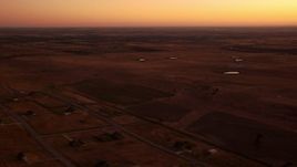 HD stock footage aerial video of flying by rural homes and farmland at sunrise in Decatur, Texas Aerial Stock Footage | HDA12_026