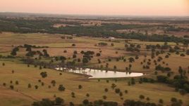 HD stock footage aerial video of a pond, rural homes and farms at sunrise, Decatur, Texas Aerial Stock Footage | HDA12_037